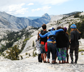 Students observe the wonder of Half Dome together from Olmstead Point. 